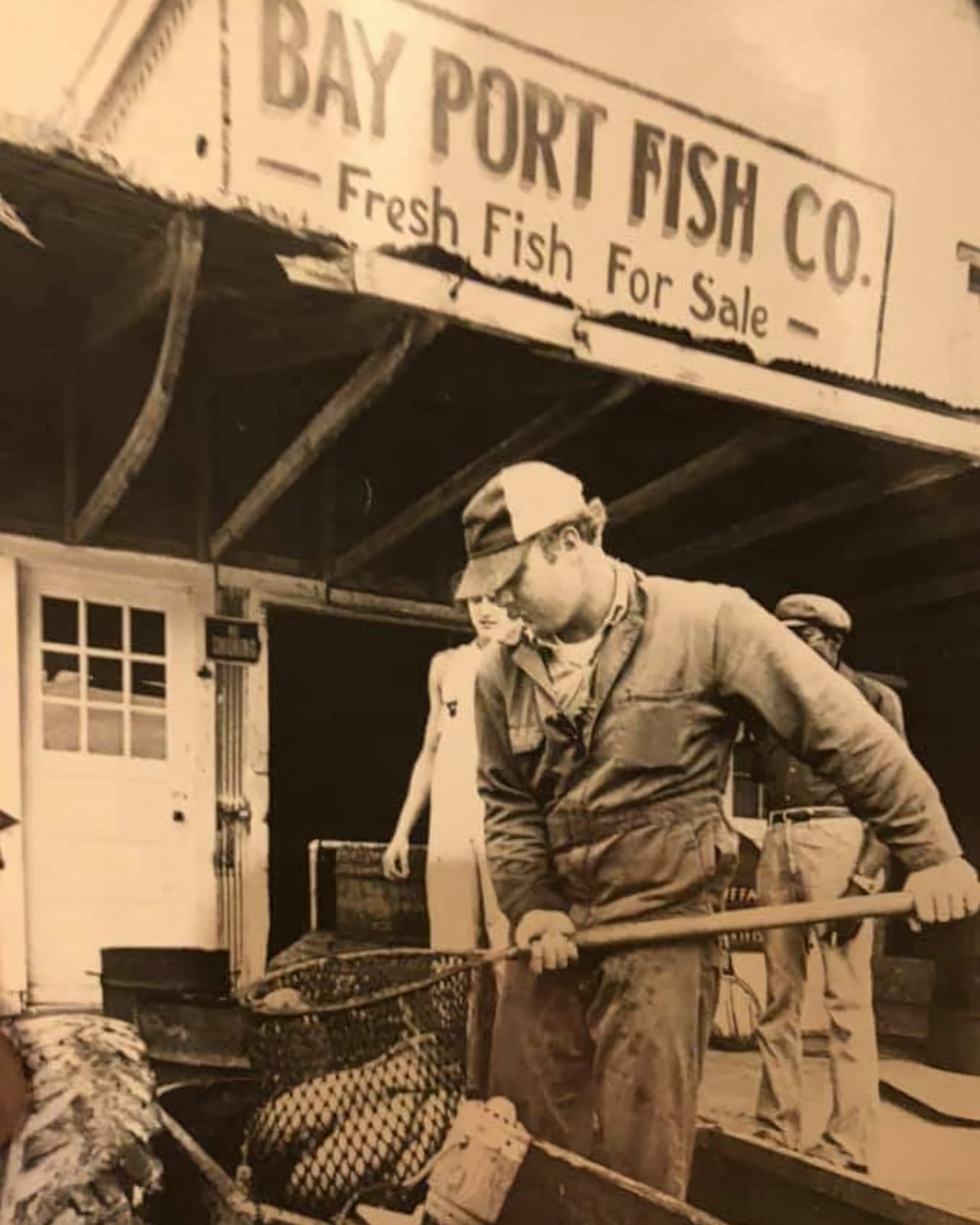 Owner Tod Williams scooping Catfish into a live hauler for transport.