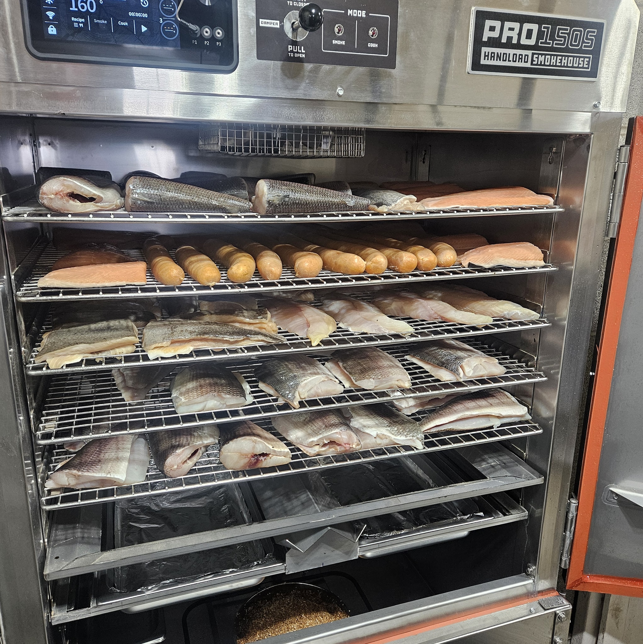 A variety of freshly brined fish loaded and ready for smoking in our new Pro Smoker!